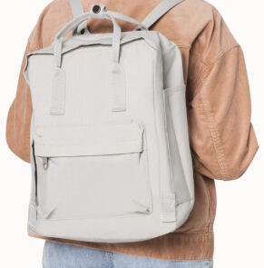 Young girl with gray student backpack